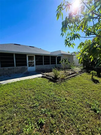 a view of a house with backyard and sitting area