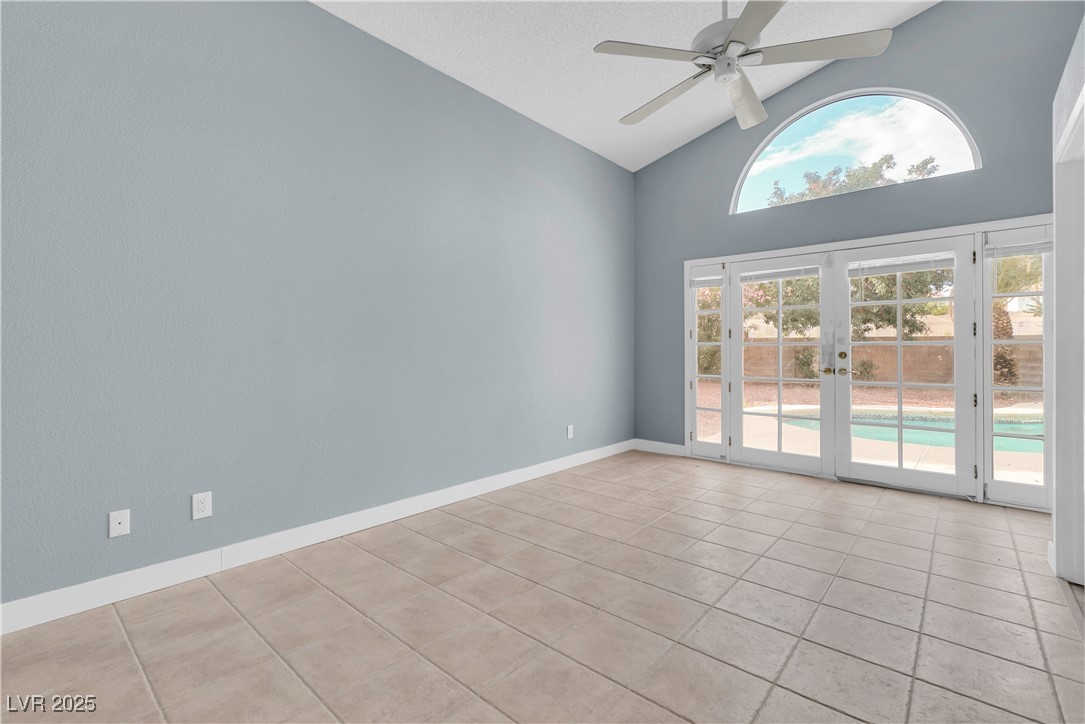2716 Knightsbridge Road Henderson, NV 89074 - Photo 16 of 27 Spare room with french doors, light tile patterned flooring, high vaulted ceiling, and a ceiling fan