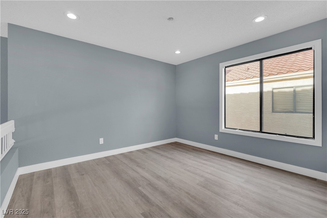 2716 Knightsbridge Road Henderson, NV 89074 - Photo 18 of 27 Empty room featuring light wood finished floors and recessed lighting
