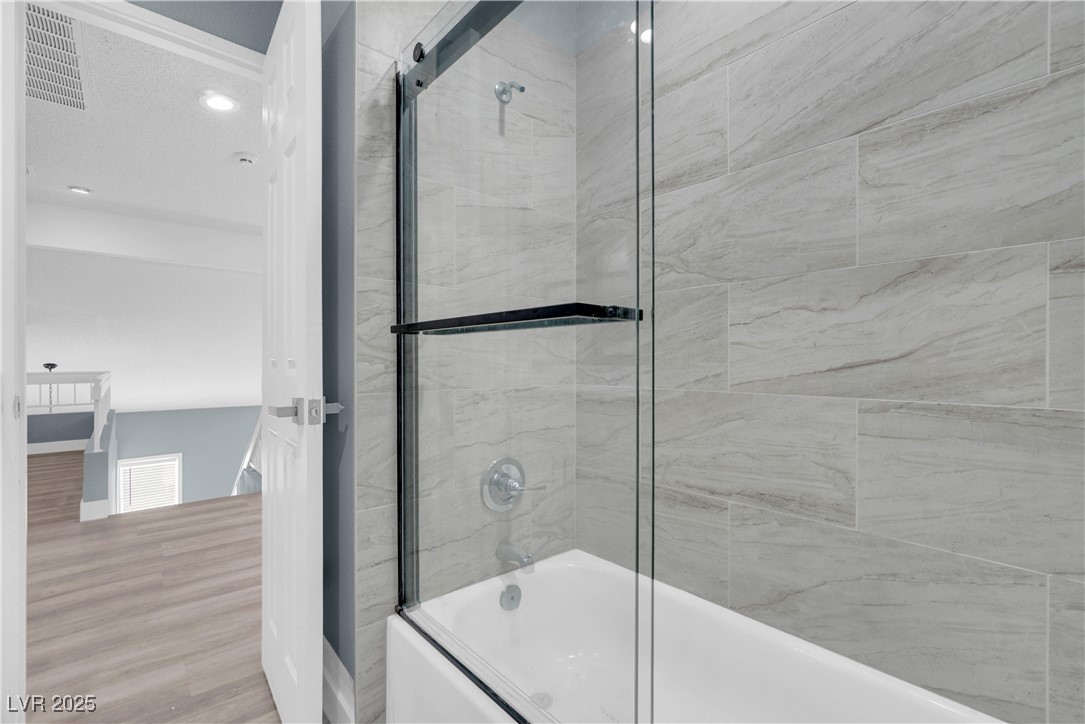 2716 Knightsbridge Road Henderson, NV 89074 - Photo 20 of 27 Full bath featuring combined bath / shower with glass door, wood finished floors, and recessed lighting