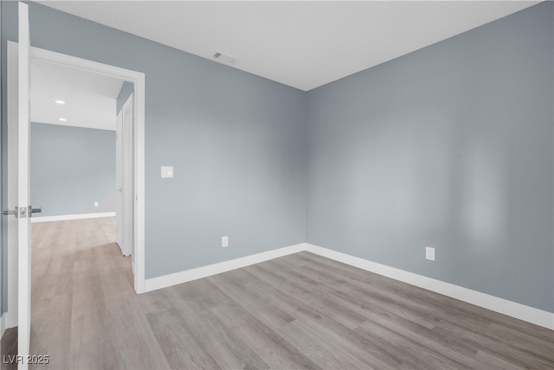2716 Knightsbridge Road Henderson, NV 89074 - Photo 6 of 27 Unfurnished room with light wood-type flooring and baseboards