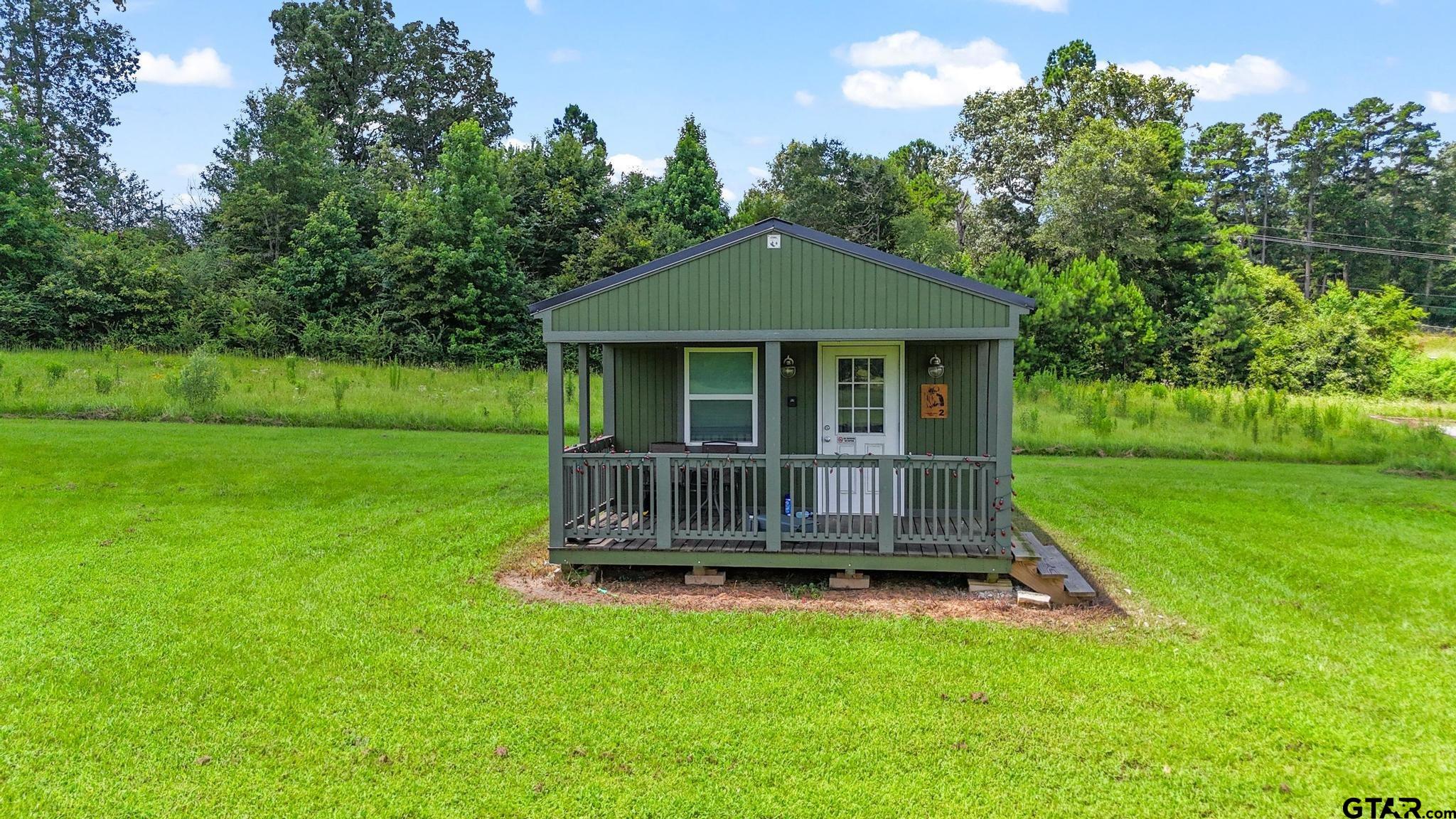 10864 State Highway 64 Overton, TX 75684 - Photo 16 of 32 a view of a house with a garden