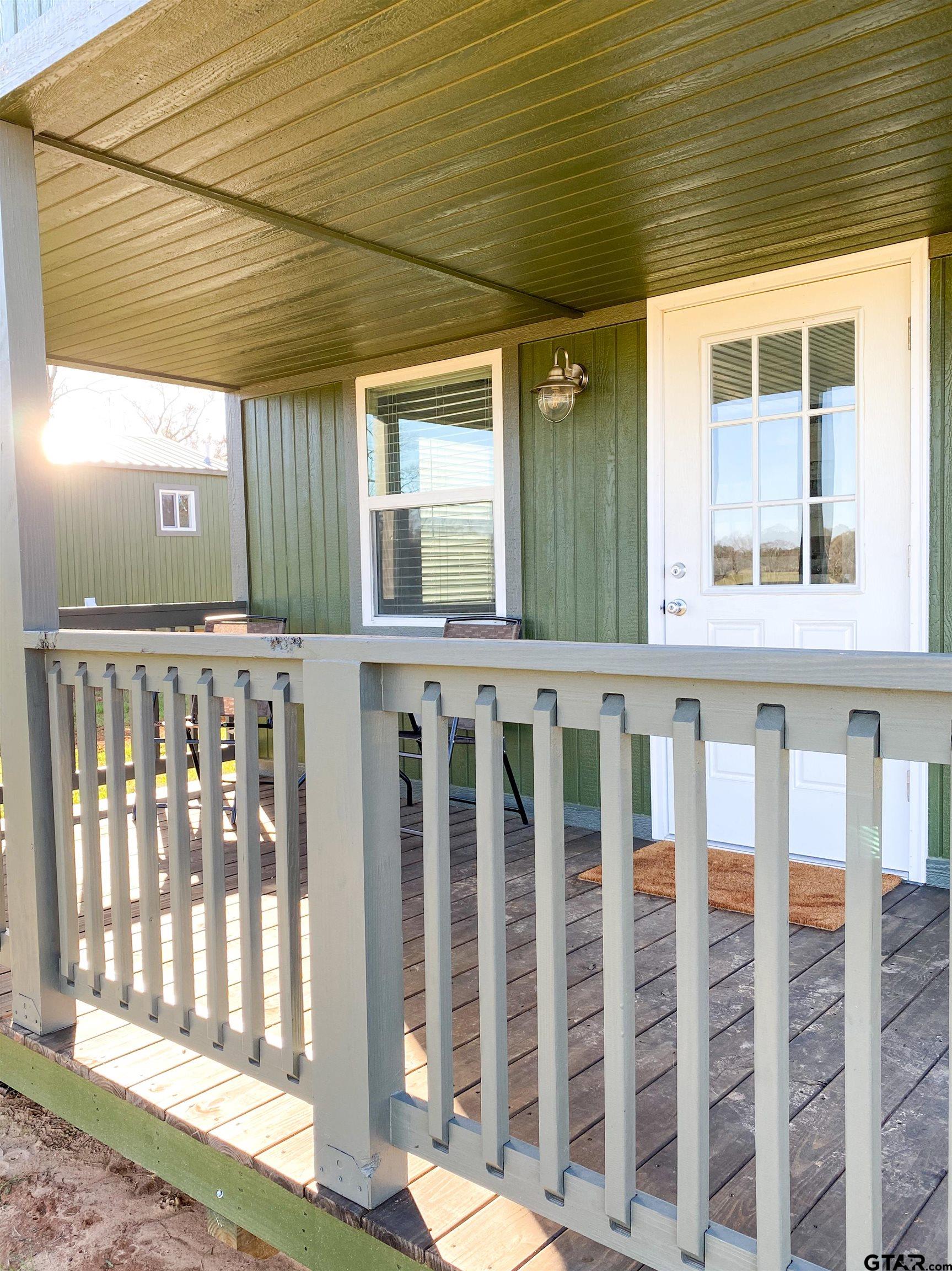 10864 State Highway 64 Overton, TX 75684 - Photo 18 of 32 a front view of a house with a porch