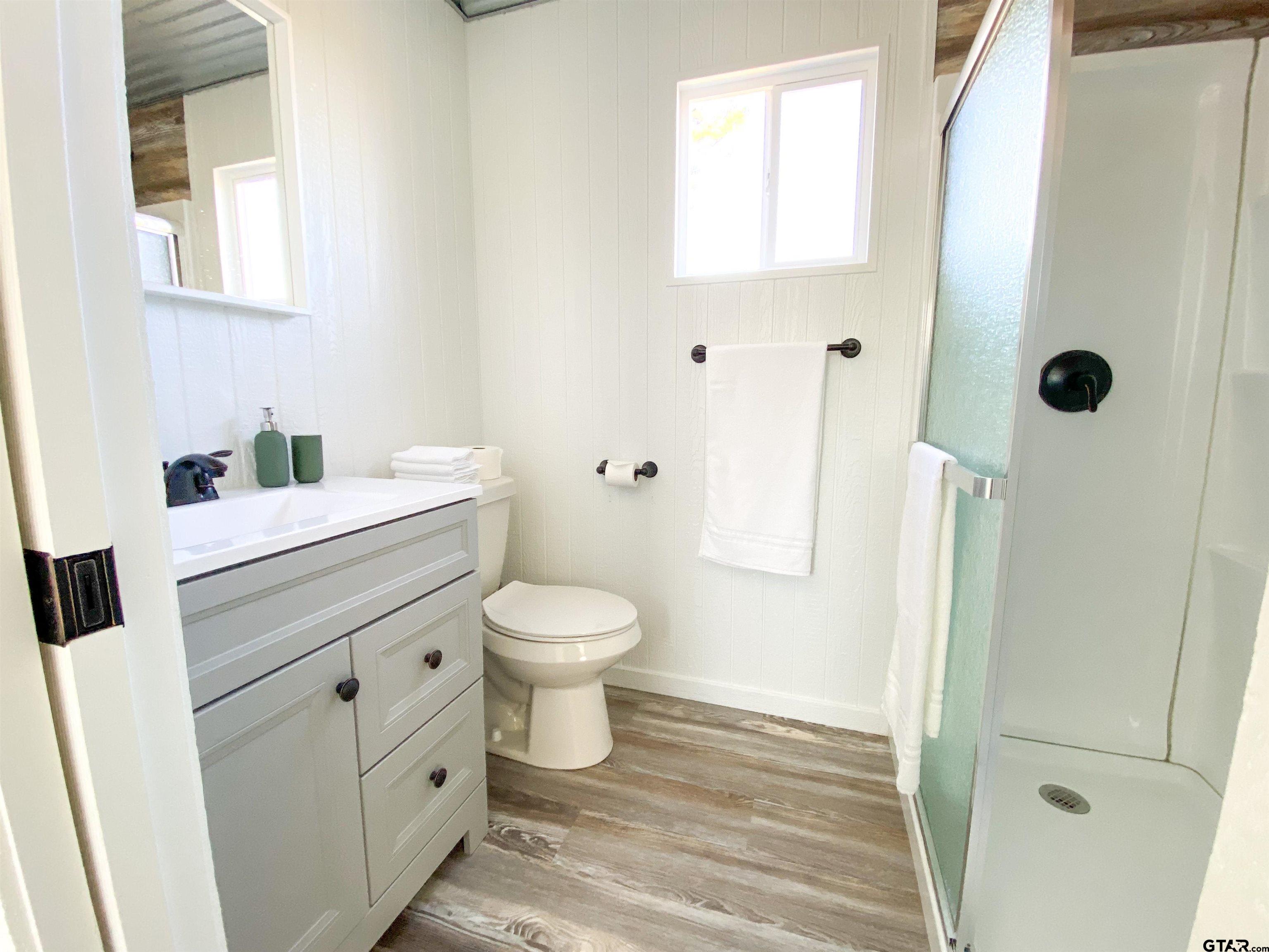 10864 State Highway 64 Overton, TX 75684 - Photo 25 of 32 a bathroom with a toilet sink and a mirror