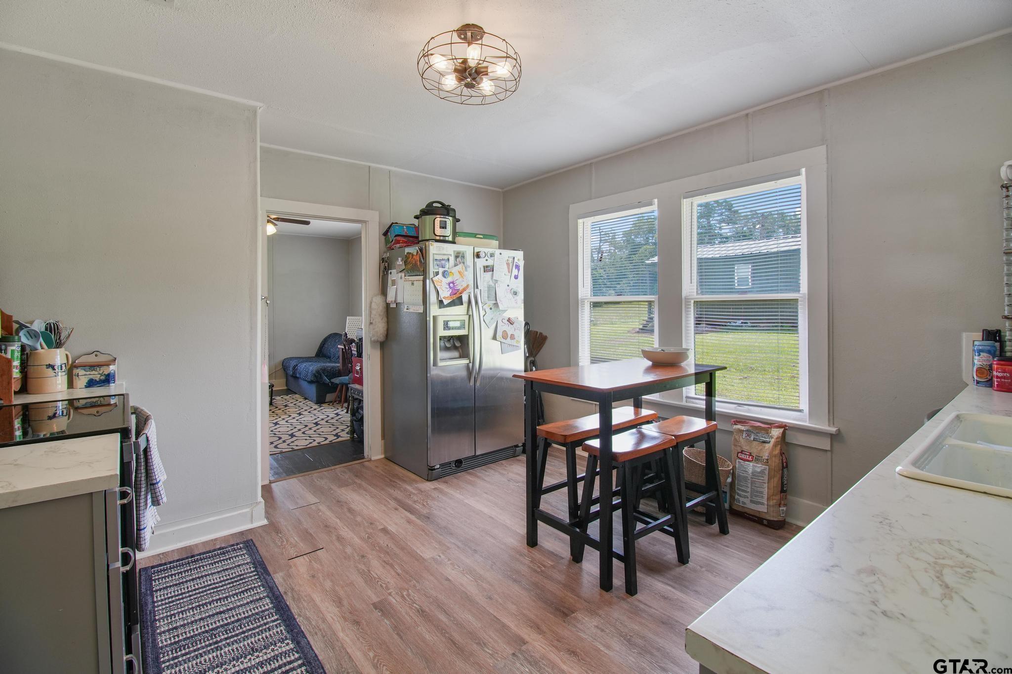10864 State Highway 64 Overton, TX 75684 - Photo 4 of 32 a view of a dining room with furniture window and wooden floor