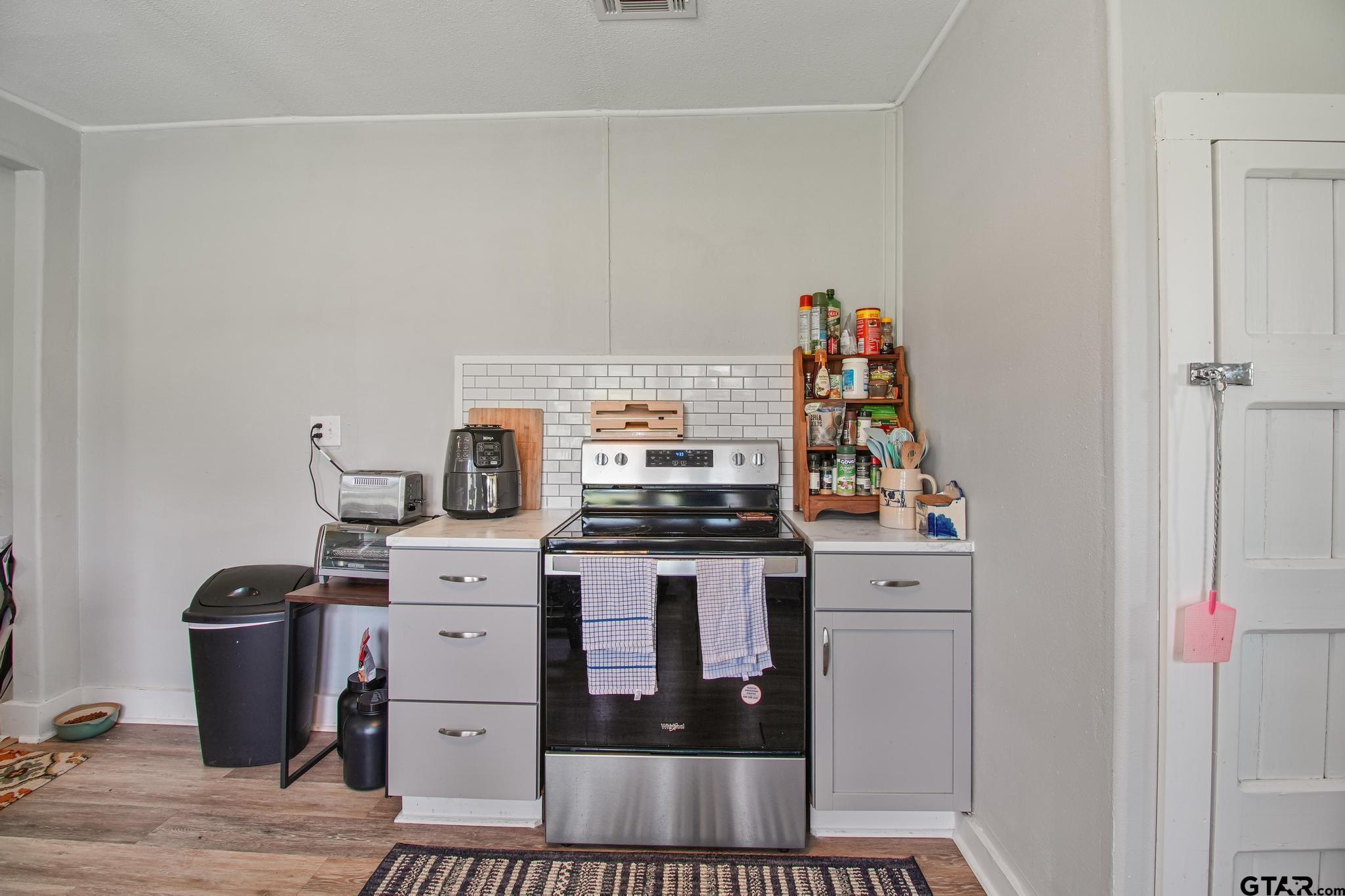 10864 State Highway 64 Overton, TX 75684 - Photo 7 of 32 a kitchen with a stove and cabinets