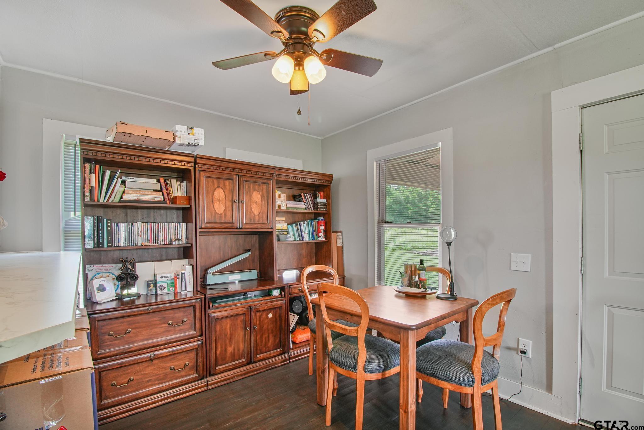 10864 State Highway 64 Overton, TX 75684 - Photo 8 of 32 a view of a dining room with furniture window and wooden floor
