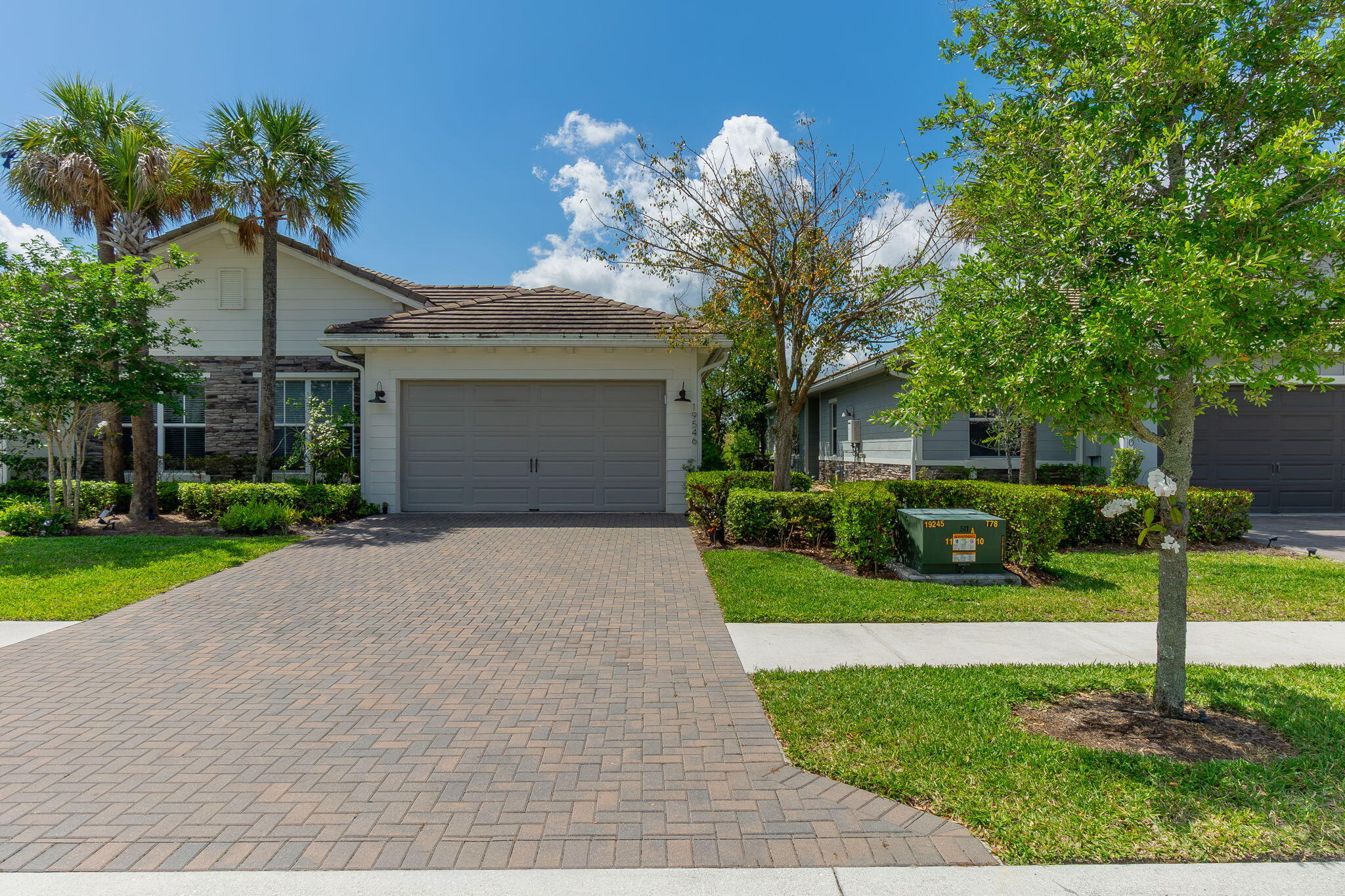 19546 Weathervane Way Loxahatchee, FL 33470 - Photo 2 of 63 a front view of a house with a yard and a garden