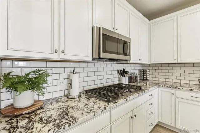 a kitchen with a stove a sink and a microwave