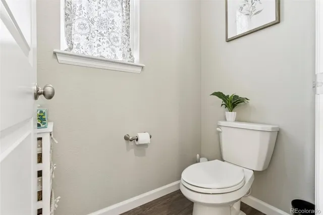 a bedroom with a bed and painting on the wall