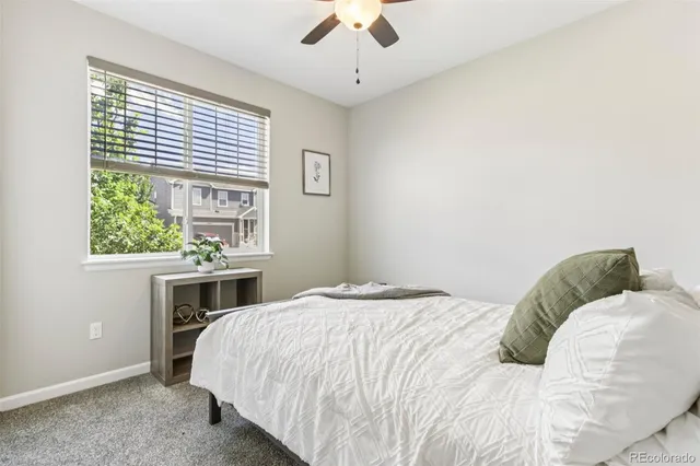 a bedroom with bed and a window