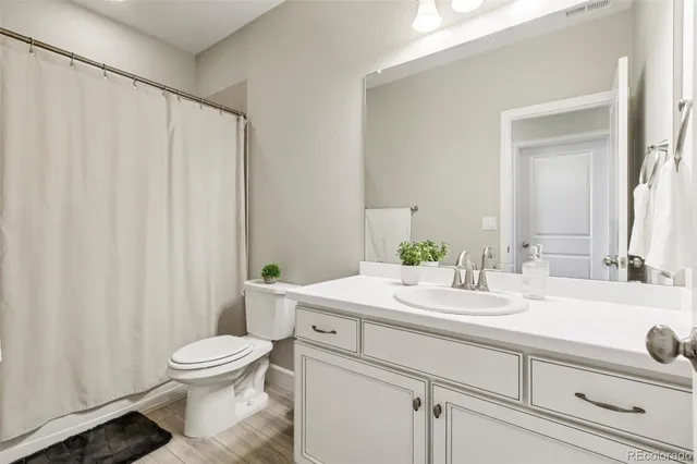 a living room with furniture and a air conditioner vent