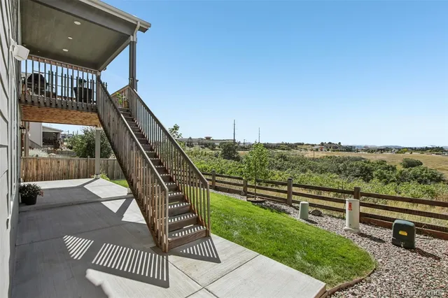 a view of a couches with wooden floor and fence