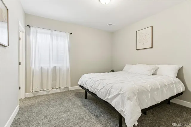 a bedroom with a bed and a desk