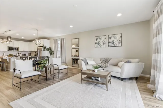 a living room with furniture and kitchen view