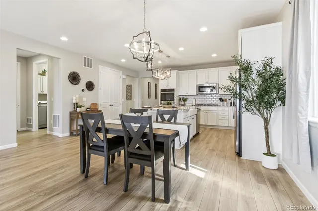 a view of a dining room with furniture and wooden floor