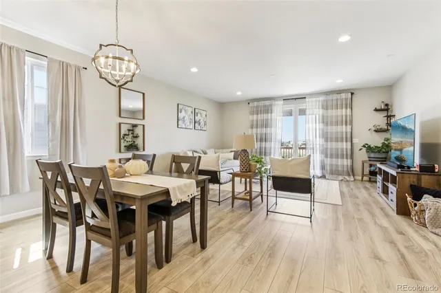 a view of a dining room with furniture window and wooden floor