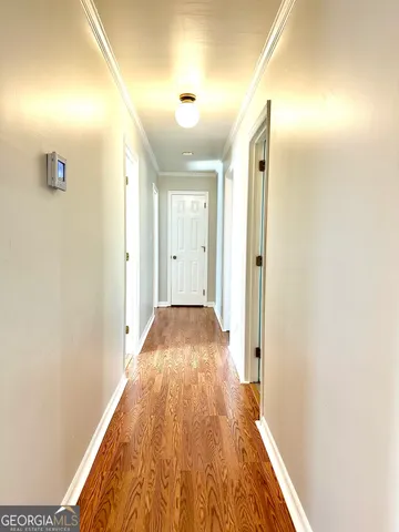 a view of hallway with wooden floor