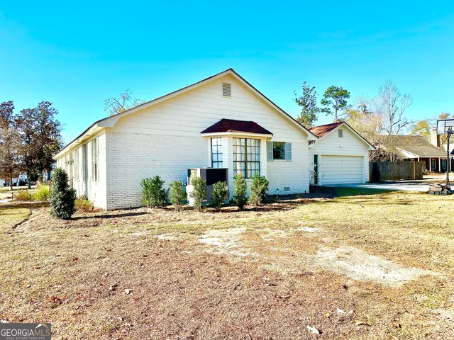 a front view of a house with a garden