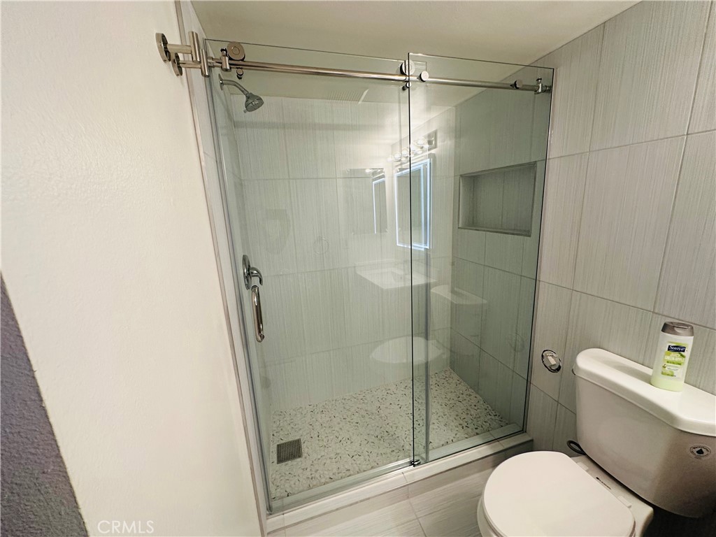 9961 Marcus Avenue, Unit 1 Tujunga, CA 91042 - Photo 12 of 16 a bathroom with a shower and toilet