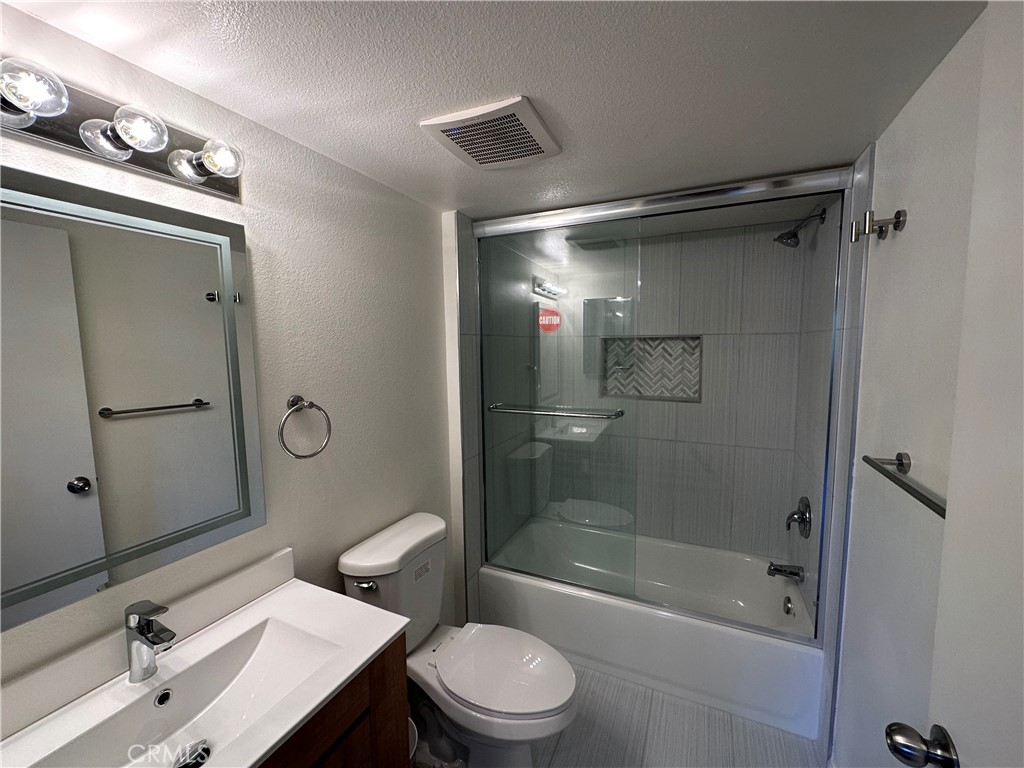 9961 Marcus Avenue, Unit 1 Tujunga, CA 91042 - Photo 3 of 16 a bathroom with a sink toilet and shower