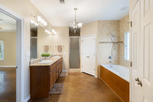 a bathroom with a tub sink and mirror