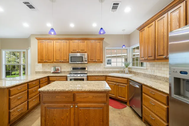 a kitchen with a sink stove top oven and cabinets