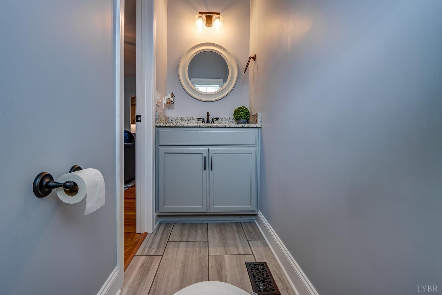 1013 Cobblestone Lane Forest, VA 24551 - Photo 11 of 49 a bathroom with a granite countertop sink and a mirror