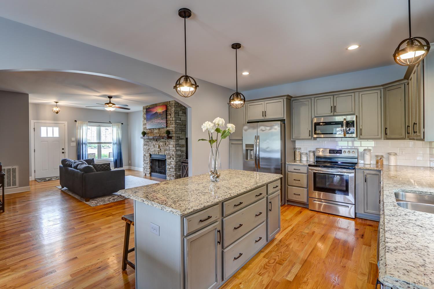 1013 Cobblestone Lane Forest, VA 24551 - Photo 15 of 49 a kitchen with stainless steel appliances kitchen island granite countertop a stove and refrigerator