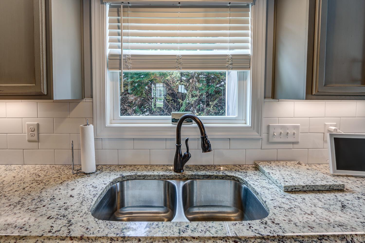 1013 Cobblestone Lane Forest, VA 24551 - Photo 19 of 49 a kitchen with granite countertop a sink and a window