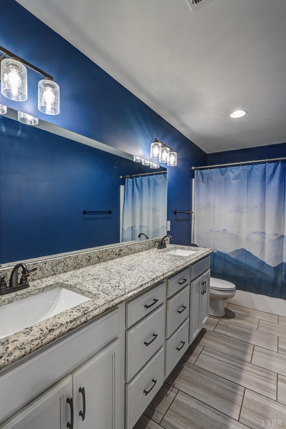 1013 Cobblestone Lane Forest, VA 24551 - Photo 28 of 49 a bathroom with a granite countertop sink and a mirror
