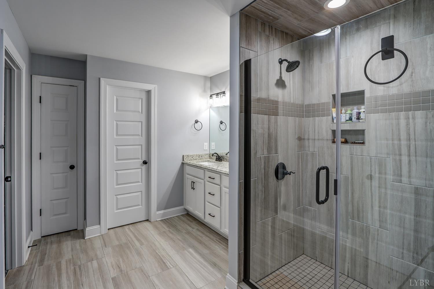 1013 Cobblestone Lane Forest, VA 24551 - Photo 35 of 49 a bathroom with a shower and a mirror