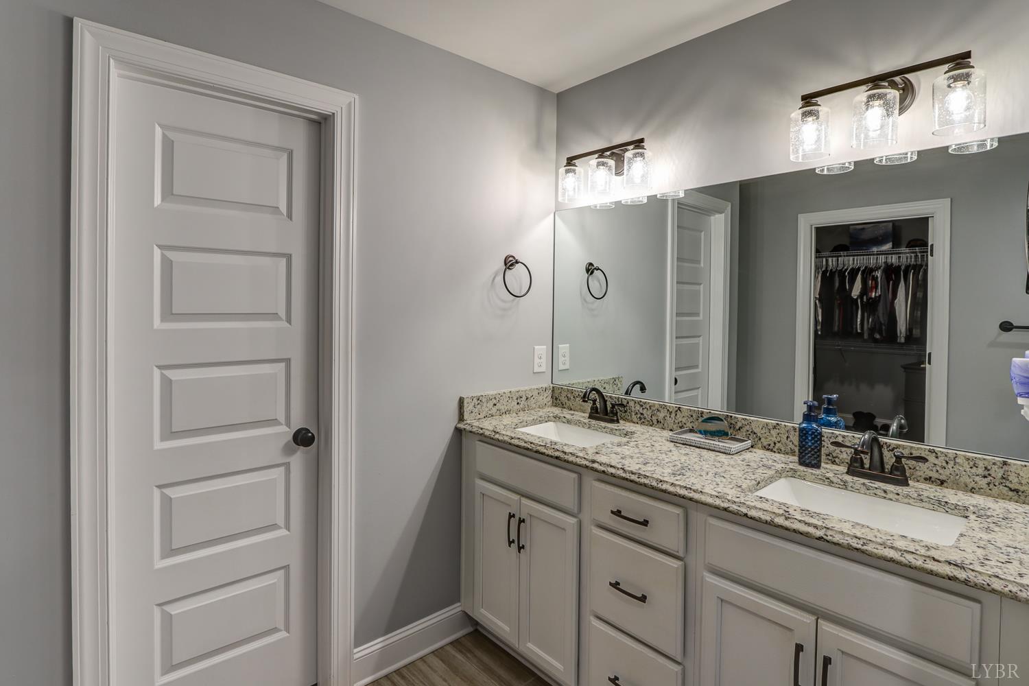 1013 Cobblestone Lane Forest, VA 24551 - Photo 36 of 49 a bathroom with a granite countertop sink double vanity and a mirror