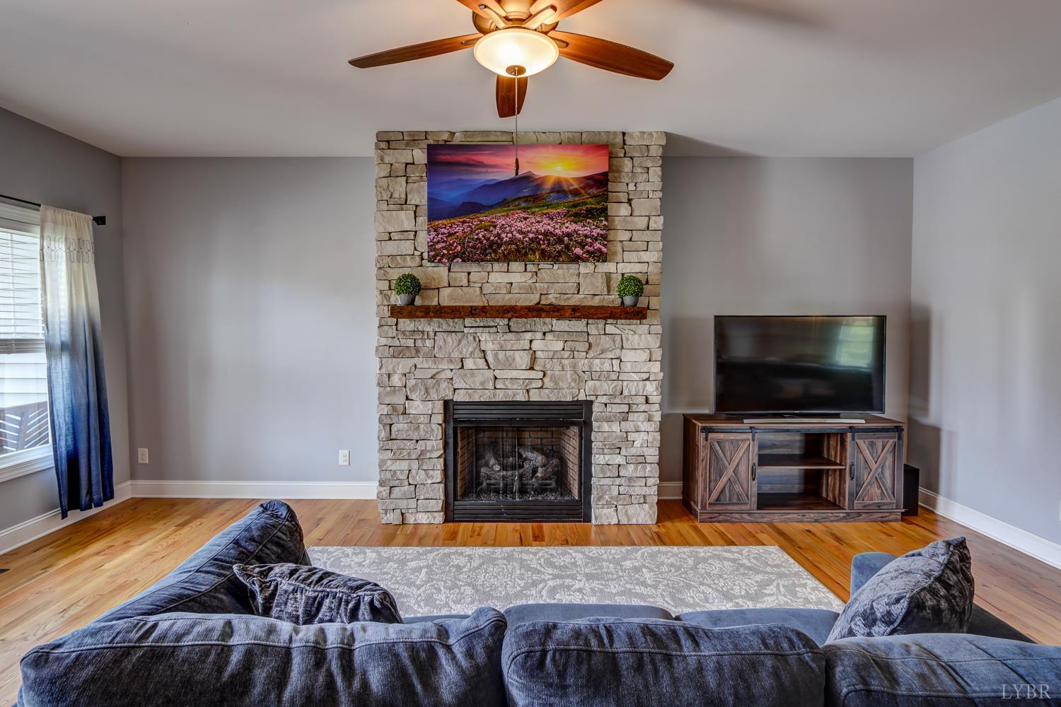 1013 Cobblestone Lane Forest, VA 24551 - Photo 6 of 49 a living room with furniture and a flat screen tv