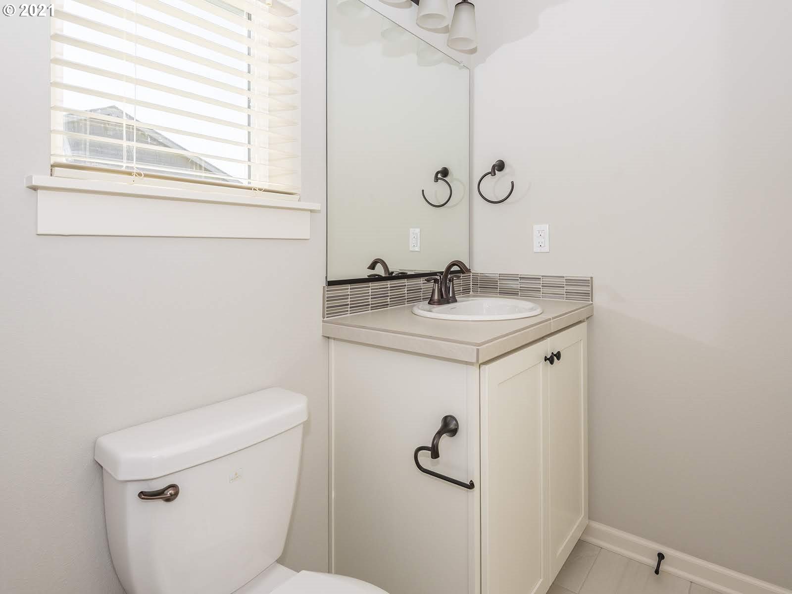 3736 South 42nd Place Ridgefield, WA 98642 - Photo 26 of 31 a bathroom with a sink a toilet and a mirror