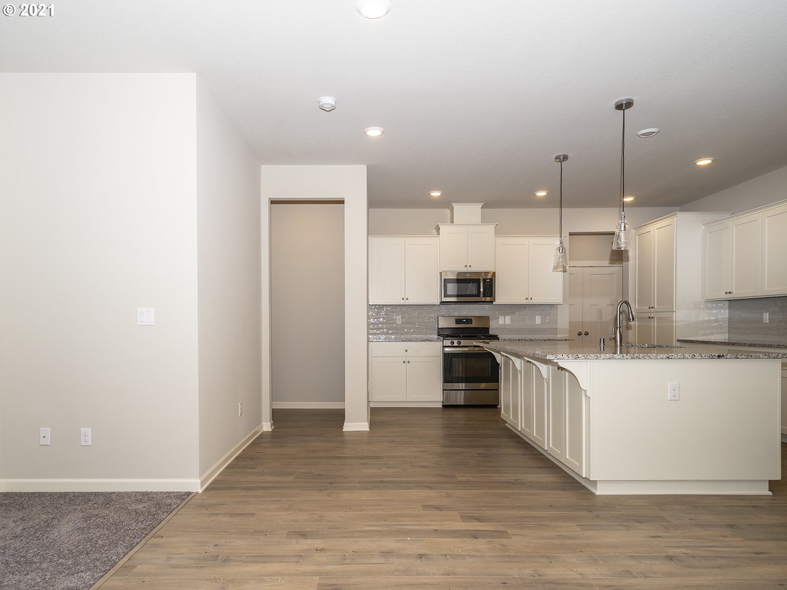 3736 South 42nd Place Ridgefield, WA 98642 - Photo 29 of 31 a large kitchen with granite countertop a large counter top a sink stainless steel appliances and cabinets