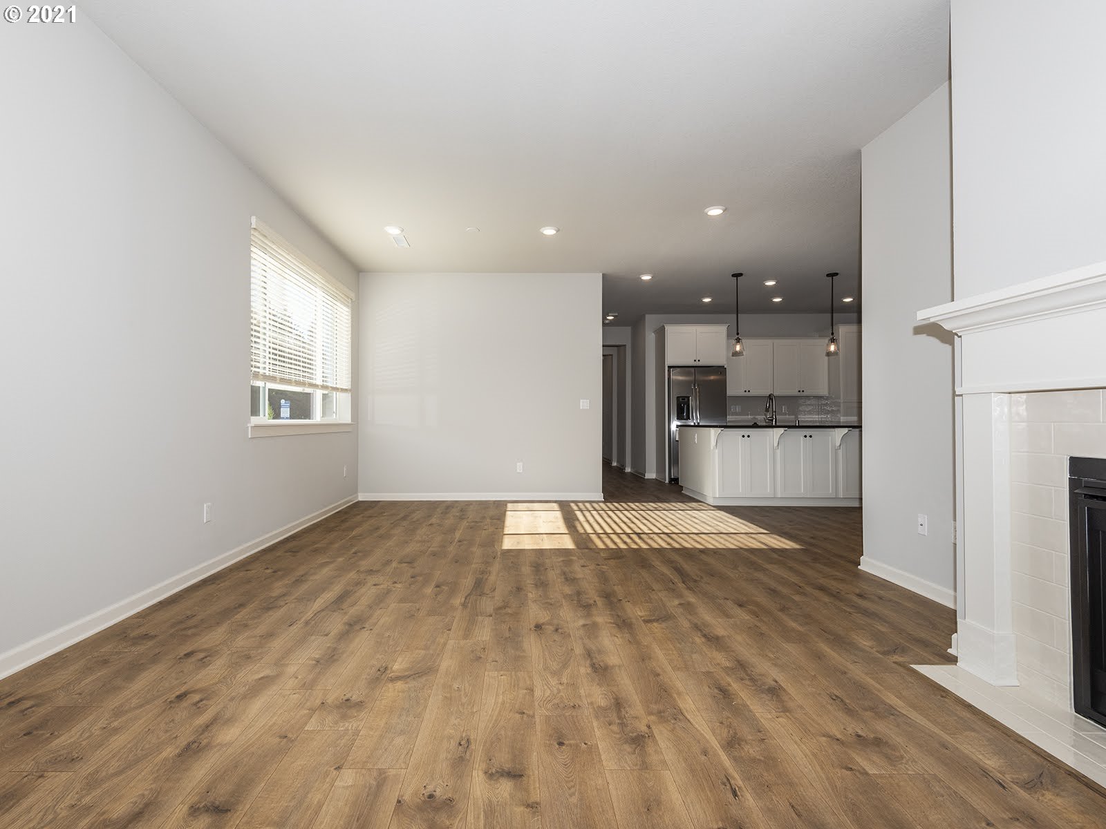 3736 South 42nd Place Ridgefield, WA 98642 - Photo 10 of 31 a view of empty room with wooden floor and kitchen
