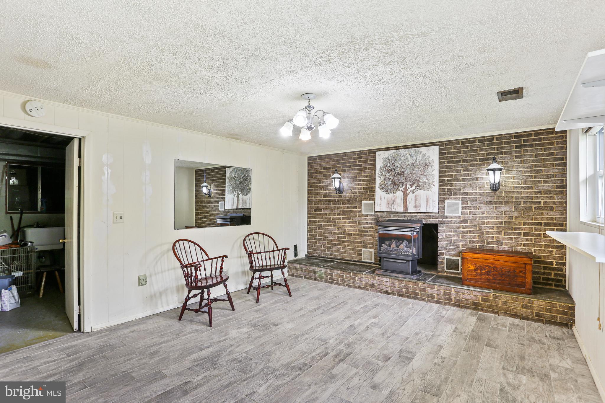 3035 Tarpon Road Riva, MD 21140 - Photo 24 of 31 a living room with furniture a fireplace and a flat screen tv
