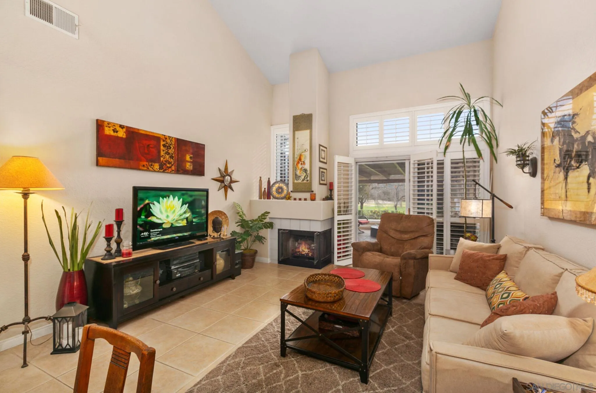 9018 Circle R Oaks Lane Escondido, CA 92026 - Photo 14 of 34 a living room with furniture a flat screen tv and a fireplace