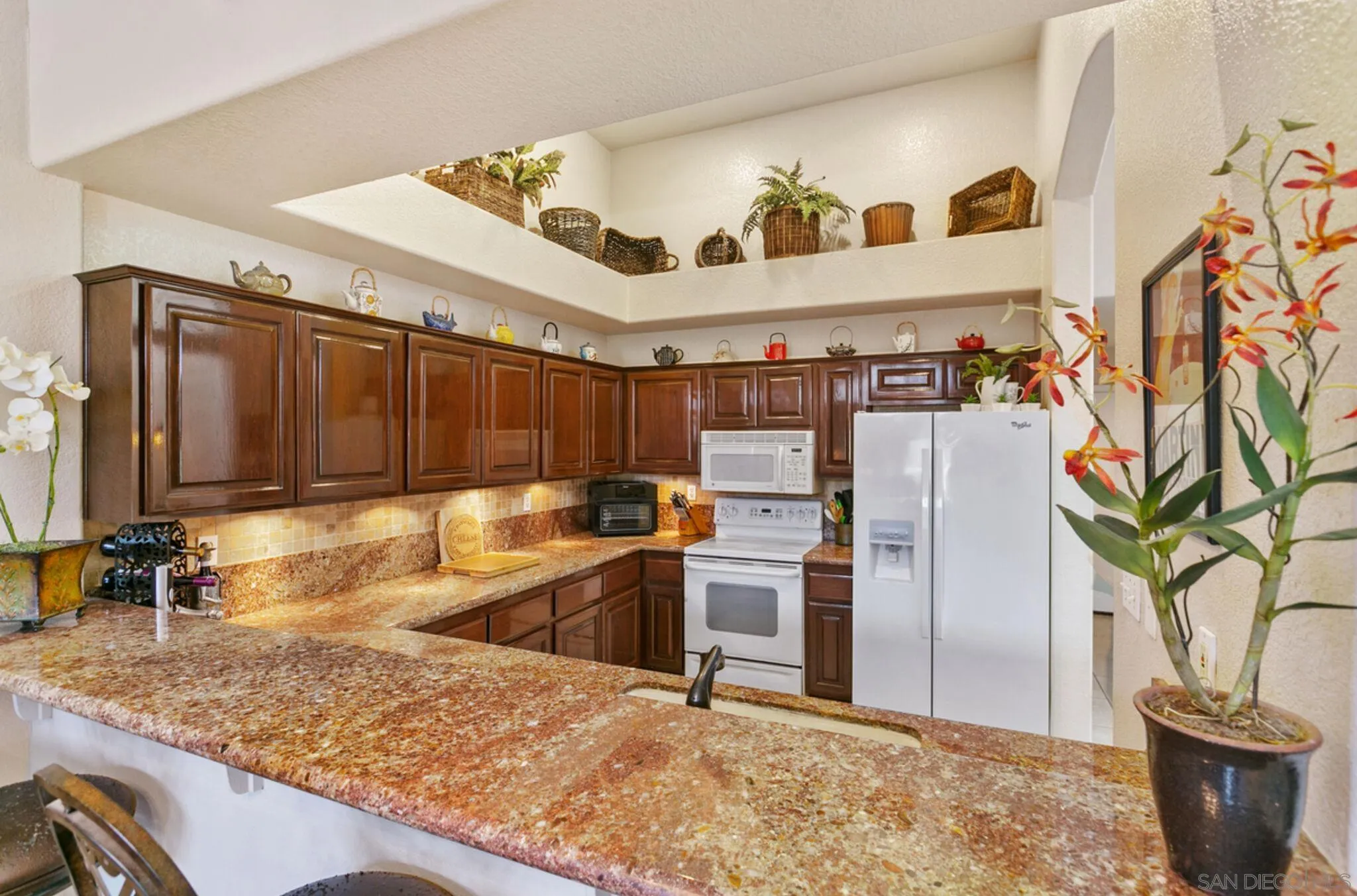 9018 Circle R Oaks Lane Escondido, CA 92026 - Photo 20 of 34 a view of a kitchen with a sink and a refrigerator