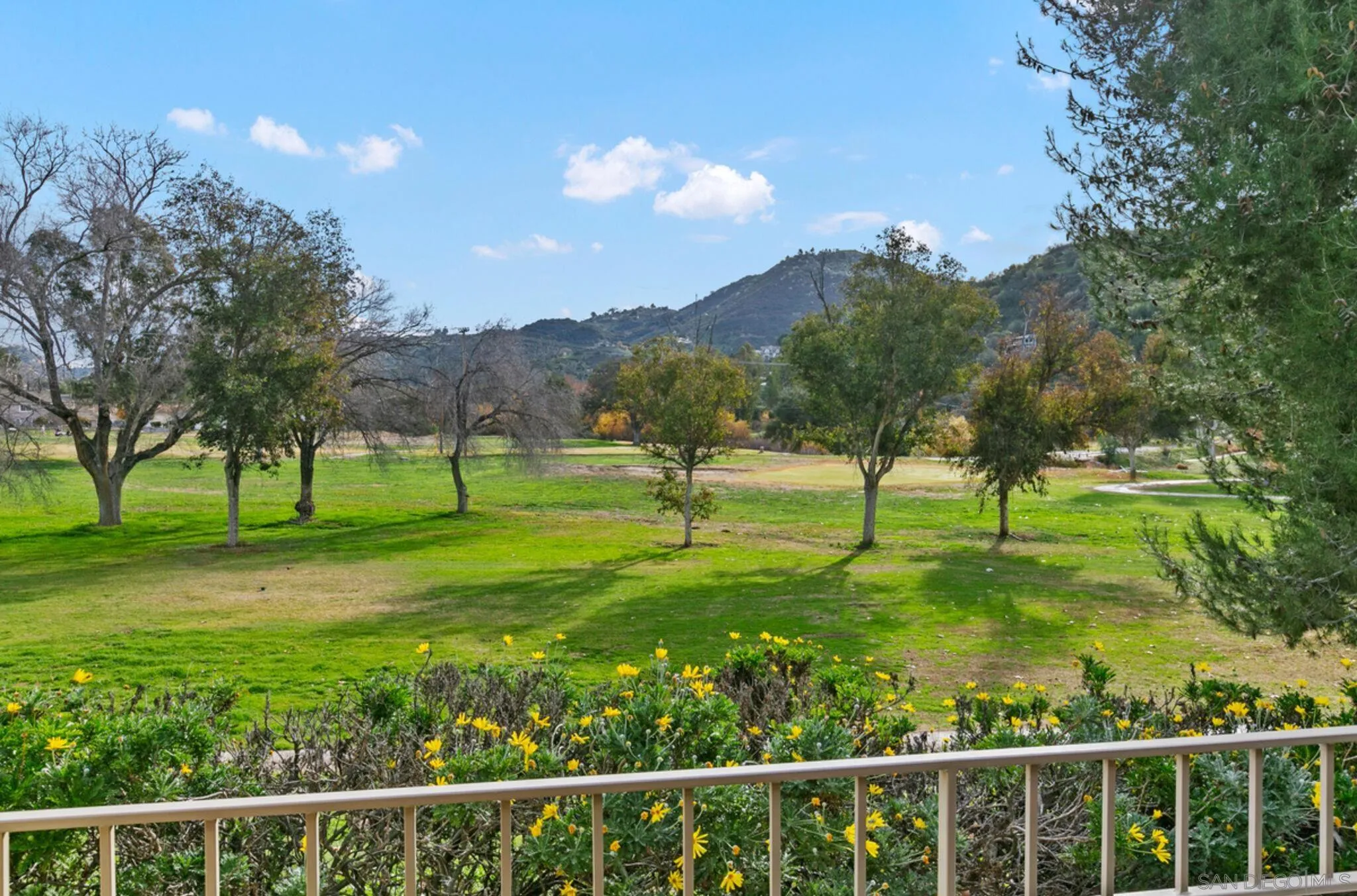 9018 Circle R Oaks Lane Escondido, CA 92026 - Photo 4 of 34 a view of a golf course with a lake