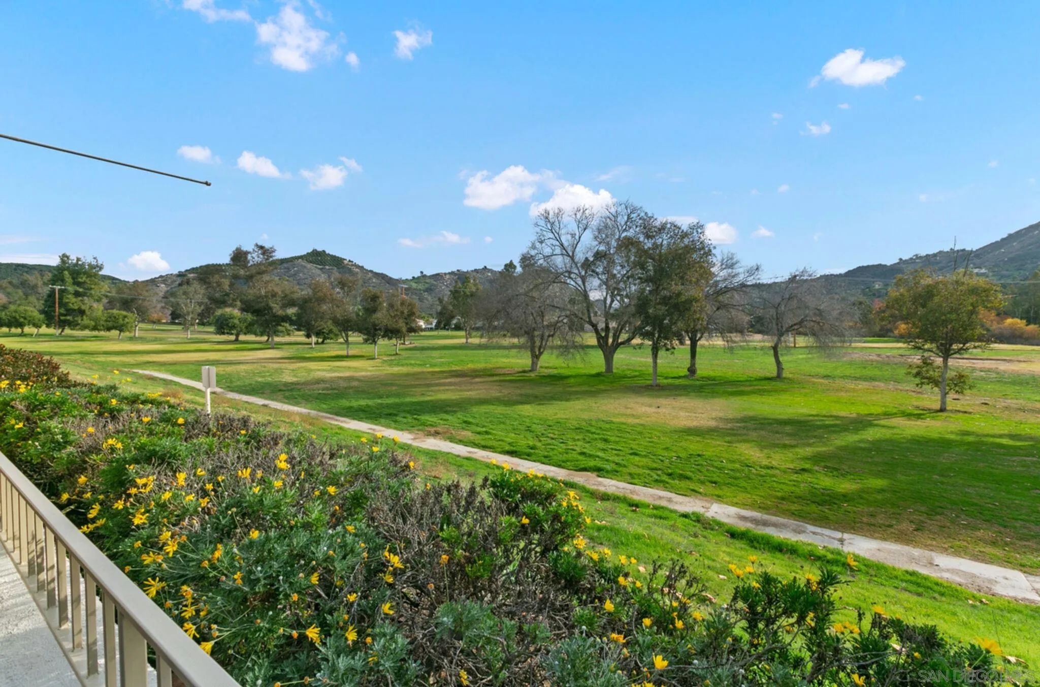 9018 Circle R Oaks Lane Escondido, CA 92026 - Photo 5 of 34 a view of a golf course with a lake