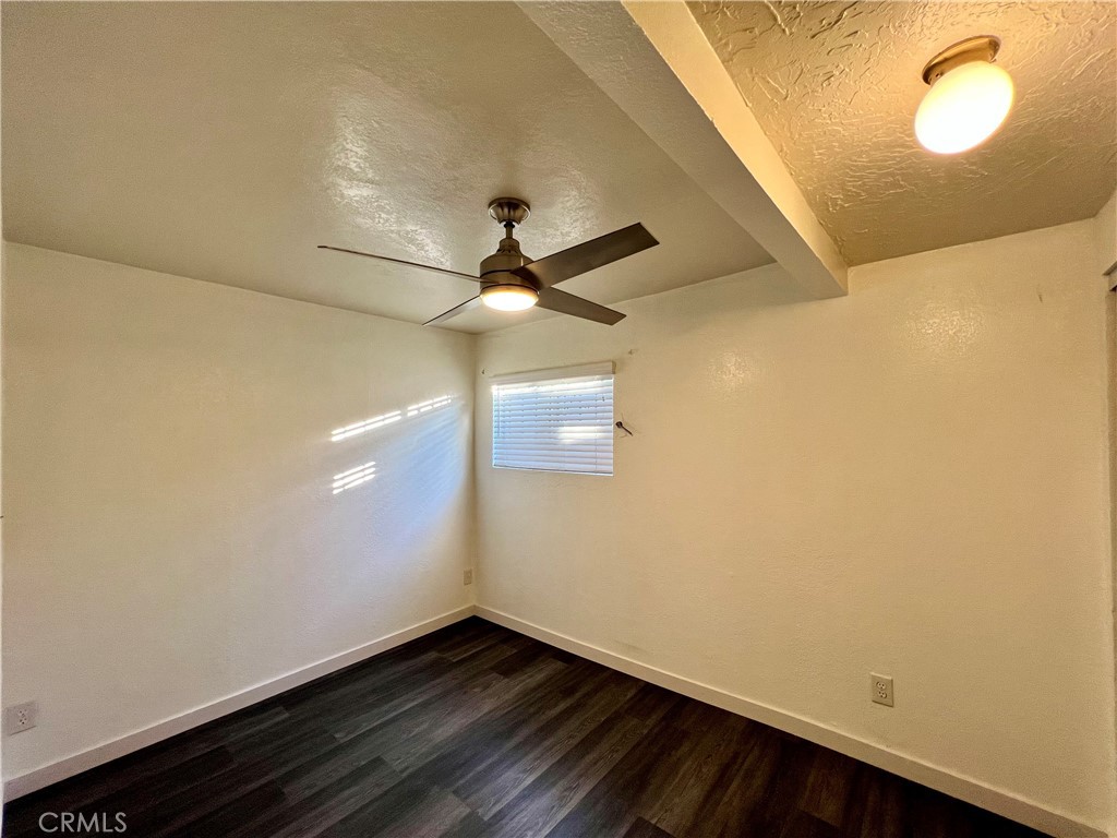 9329 Elizabeth Avenue South Gate, CA 90280 - Photo 6 of 8 en empty room with wooden floor and fan
