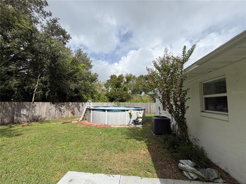 1405 Crystal Court, Unit C Tavares, FL 32778 - Photo 15 of 15 a front view of house with yard and trees in the background