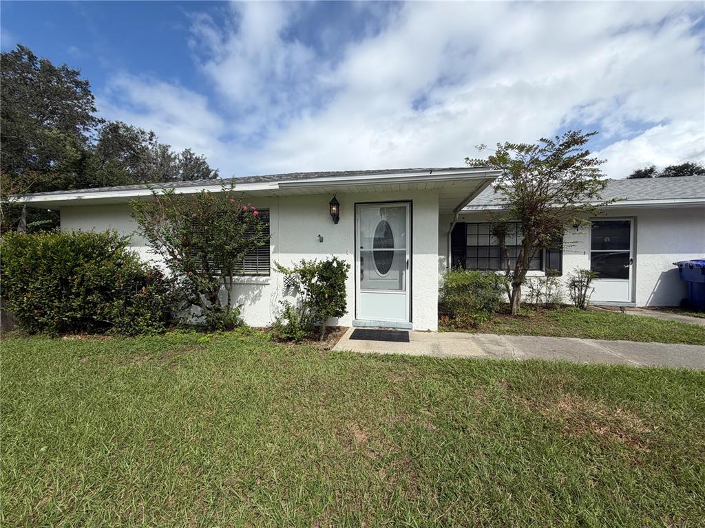 1405 Crystal Court, Unit C Tavares, FL 32778 - Photo 2 of 15 a front view of a house with garden