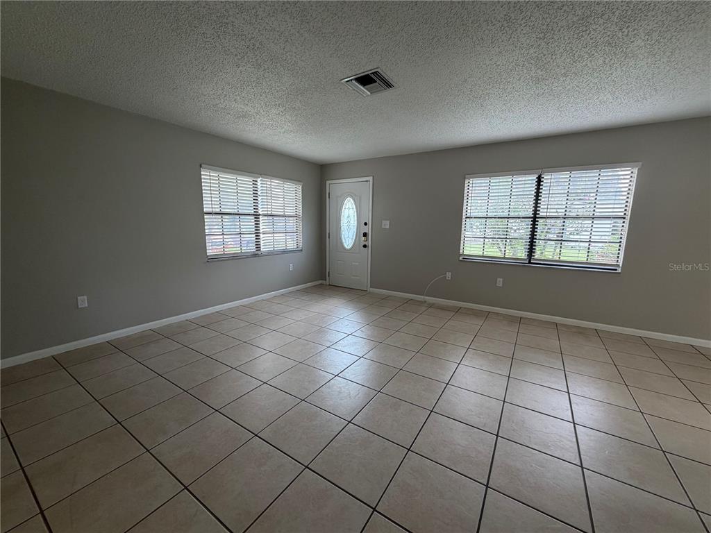 1405 Crystal Court, Unit C Tavares, FL 32778 - Photo 6 of 15 an empty room with windows