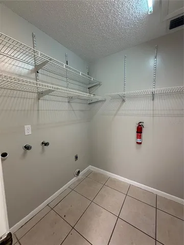 a view of storage and utility room with racks on the wall
