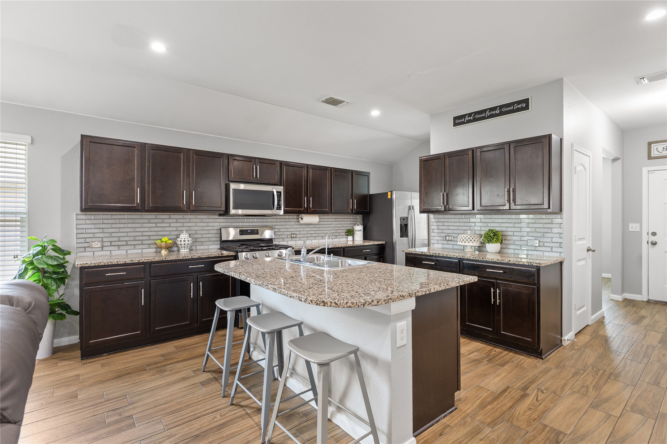 256 Alpha Kyle, TX 78640 - Photo 6 of 27 Granite counters and stainless steel appliances complete this open-concept culinary space.