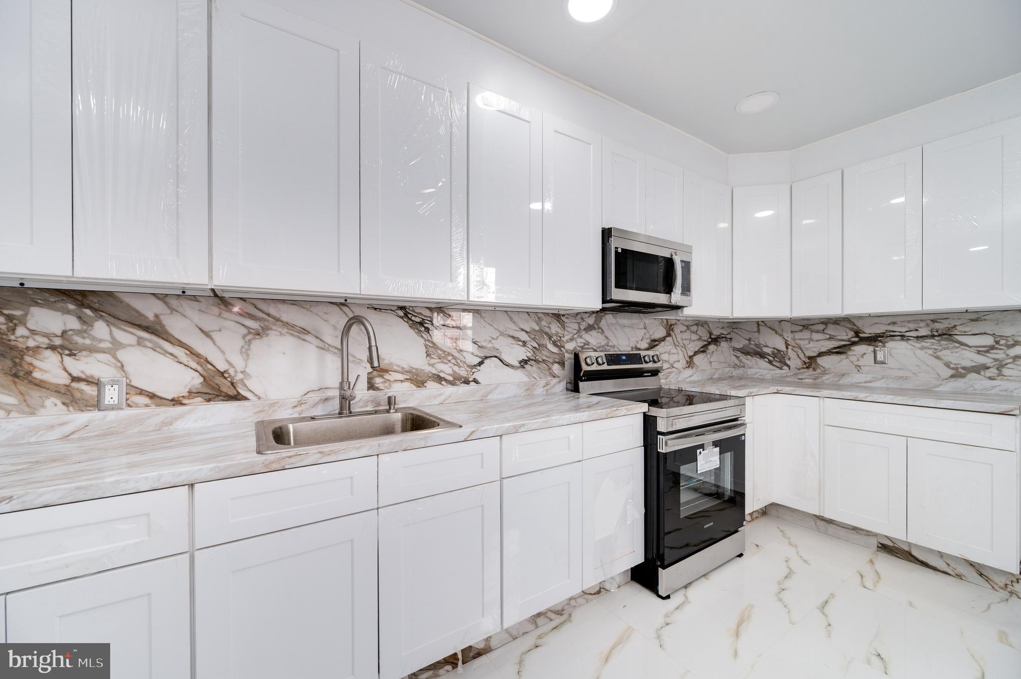 2024 Kutztown Road Reading, PA 19605 - Photo 12 of 38 a kitchen with stainless steel appliances granite countertop a sink and a stove top oven