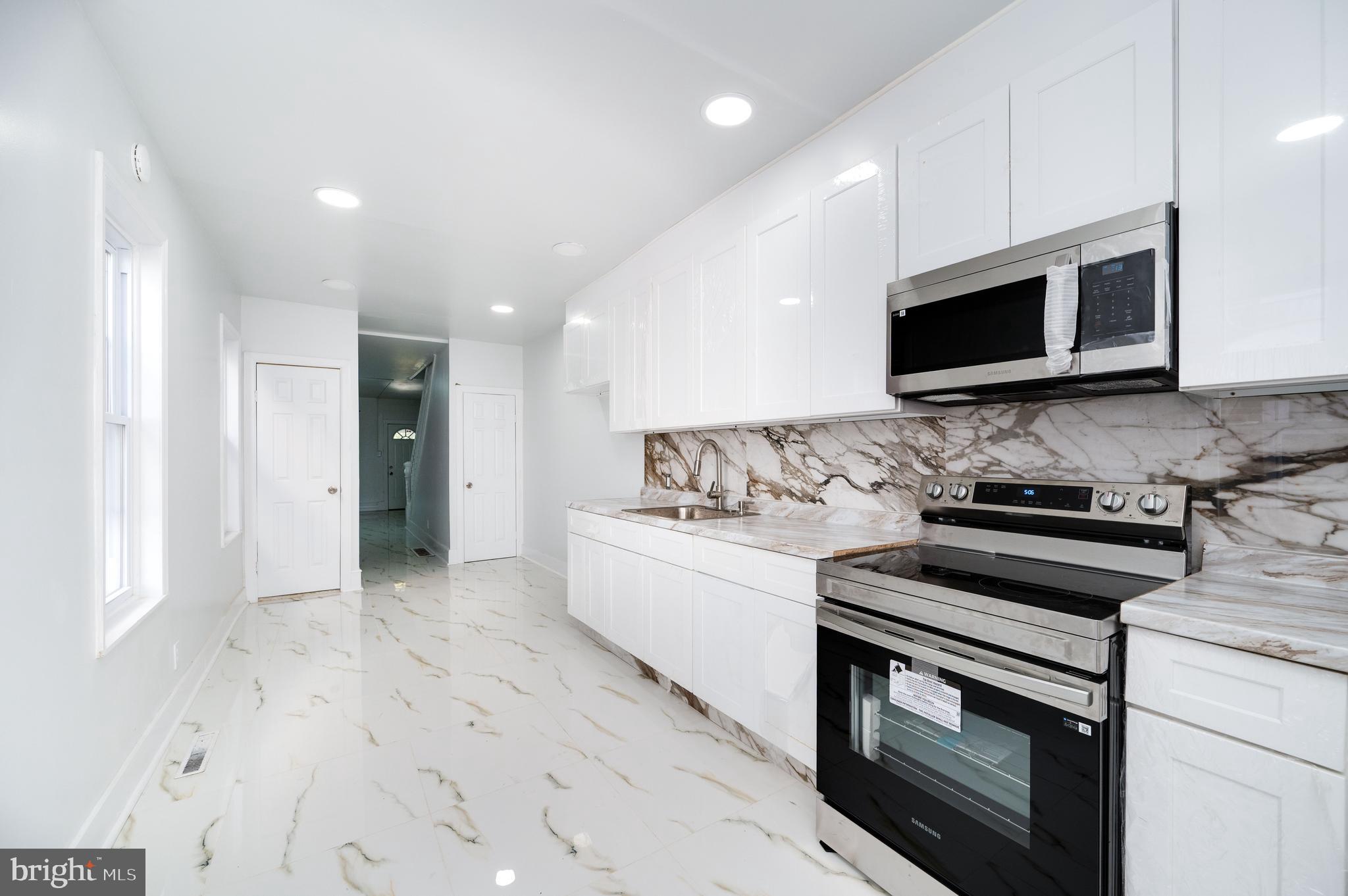 2024 Kutztown Road Reading, PA 19605 - Photo 14 of 38 a kitchen with stainless steel appliances granite countertop a stove a microwave and a sink